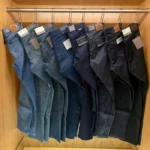 Picture of jeans hanging on a rack.