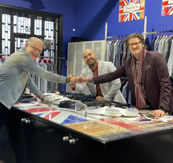 David Eisele reviewing fabrics with clients at Davelle Clothiers
