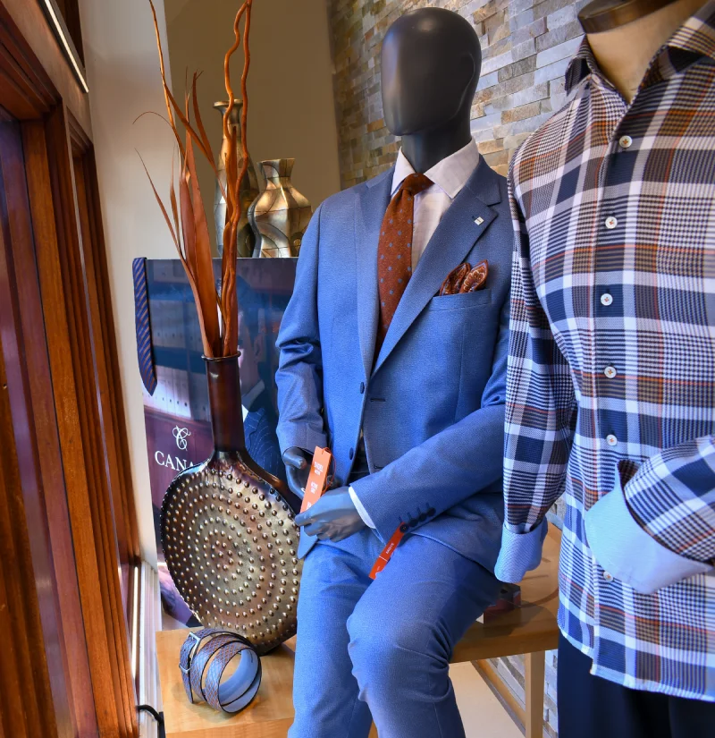 Men's suits and sport coats on display at Davelle Clothiers