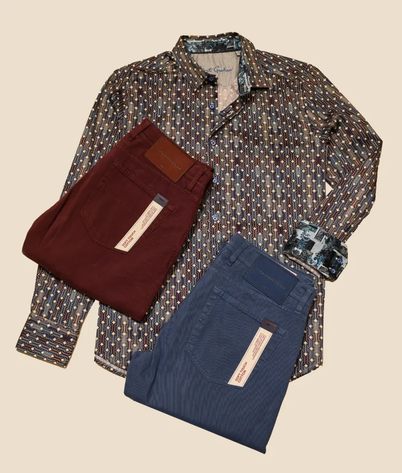 Patterned men’s dress shirt paired with burgundy and blue trousers.